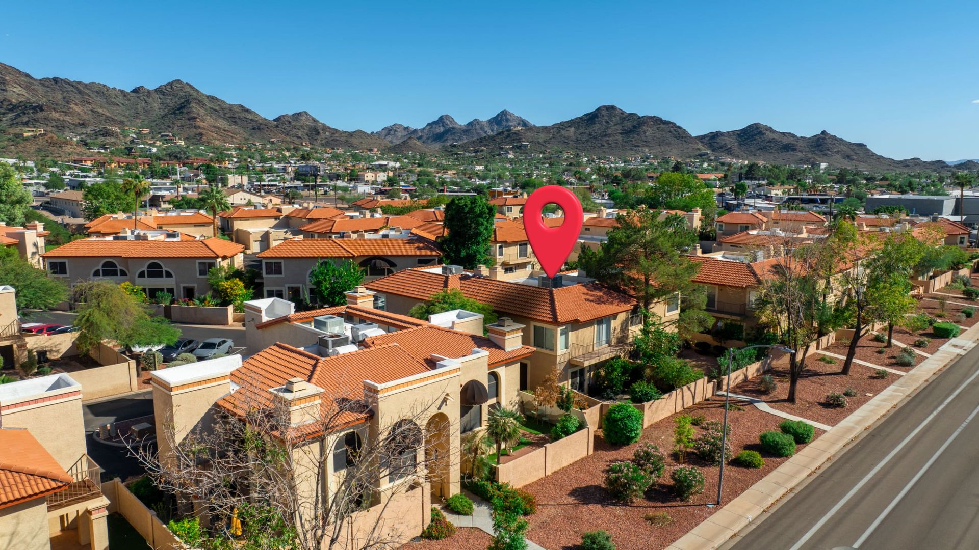Property location marked with a map pin, mountains behind