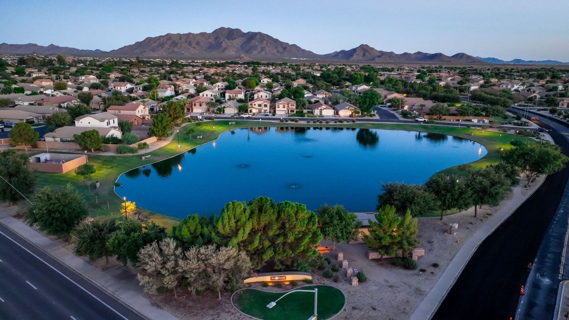 Sun Groves lake with mountains on the horizon